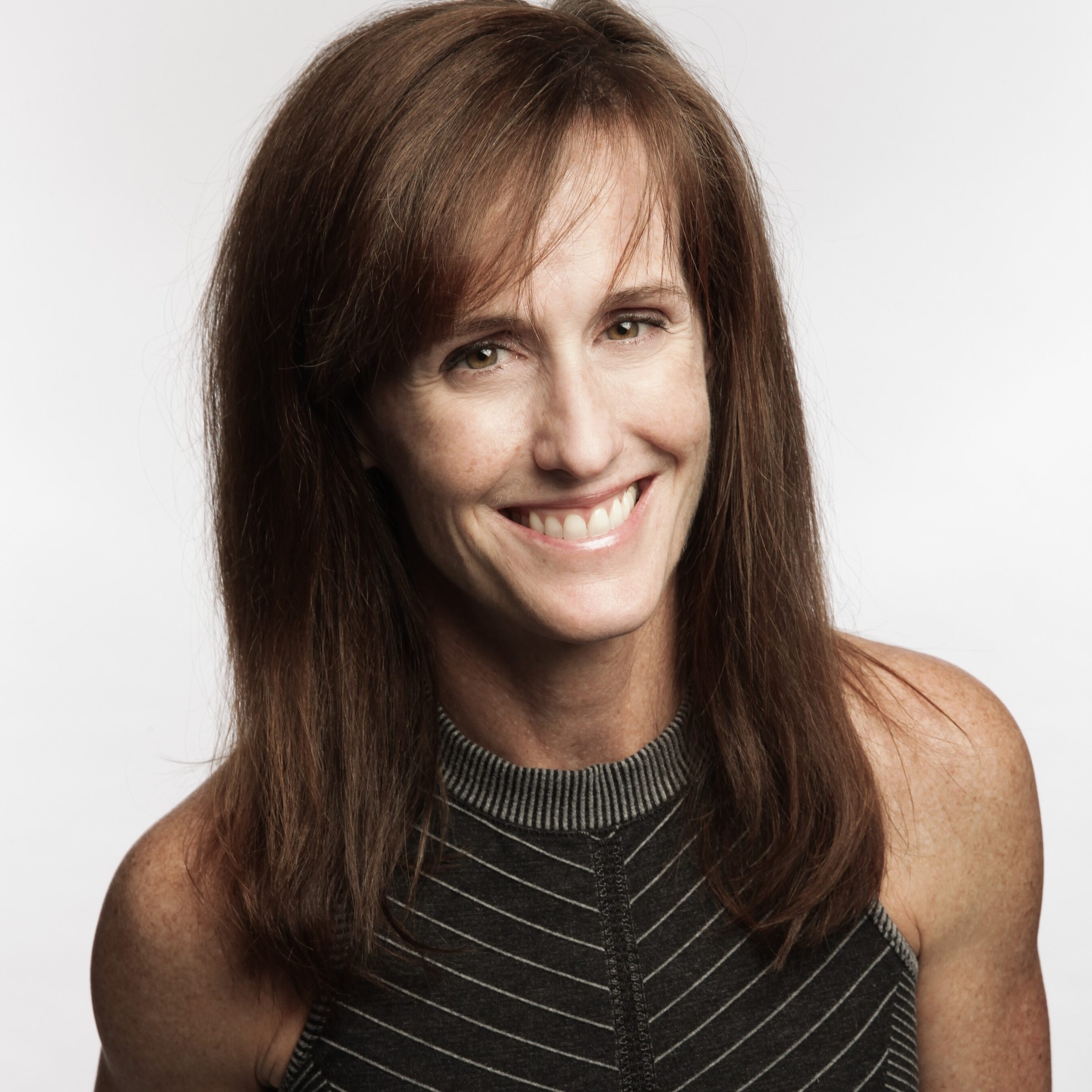 Smiling woman with long brown hair.